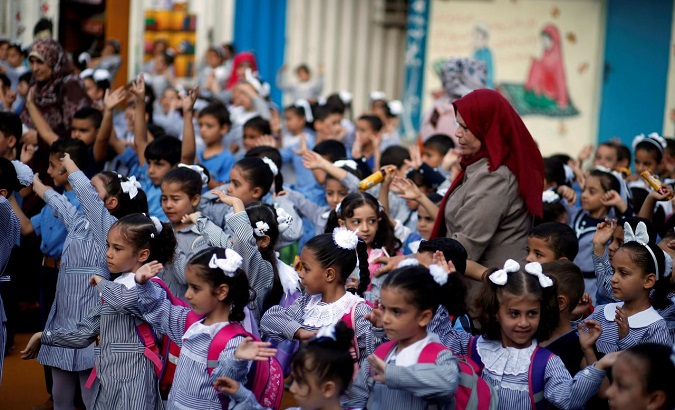Palestinian schoolchildren participate in the morning exercise at an UNRWA-run school, on the first day of a new school year, in Gaza City Aug. 29, 2018.