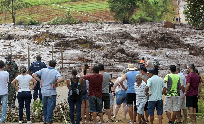 Residents are seen on a blocked road after a dam, owned by Brazilian mining company Vale SA, burst in Brumadinho, Brazil Jan. 26, 2019.