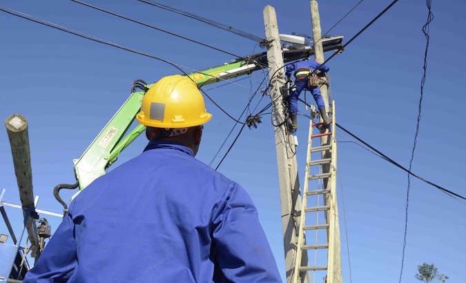 Workers from the Cuban electricity company working to repair a post damaged by the violent tornado in Havana. Jan. 30, 2019.