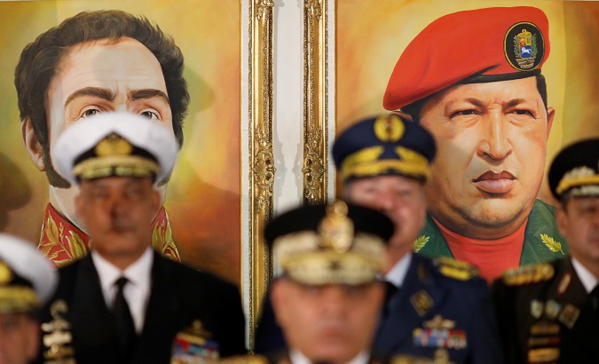 Portraits of Simon Bolivar and Venezuela's late President Hugo Chavez are seen during a news conference, Venezuela Jan. 24, 2019.