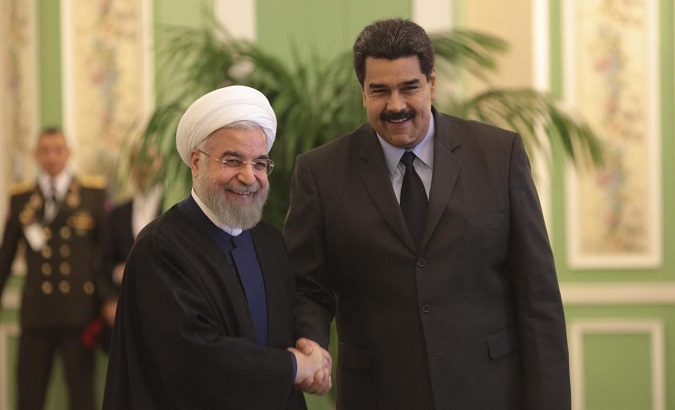Venezuela's President Nicolas Maduro (R) is welcomed by Iran's President Hassan Rouhani in Tehran January 10, 2015.