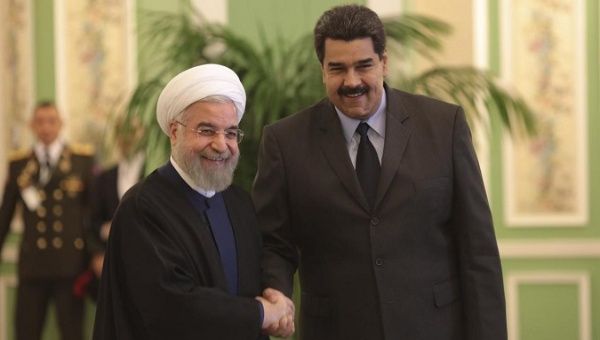 Venezuela's President Nicolas Maduro (R) is welcomed by Iran's President Hassan Rouhani in Tehran January 10, 2015.