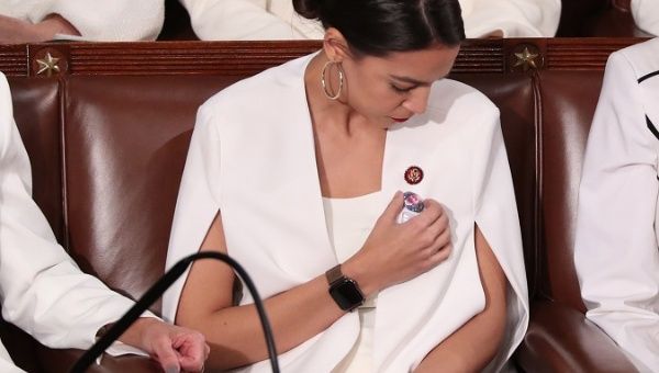 Alexandria Ocasio-Cortez pointing at her button of Jakelin Caal, the migrant child who died at the U.S. border custody. 