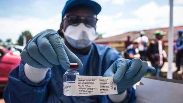 A WHO worker shows an anti-Ebola vaccine in Mbandaka, DR Congo, May 21, 2018.