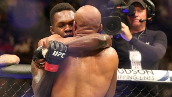 Israel Adesanya and Anderson Silva share an embrace, after the formers' win over the Brazilian legend, at UFC 234 in Melbourne, Australia.