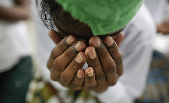 A suspected victim of human trafficking prays at a government shelter in Takua Pa district of Phang Nga October 17, 2014.