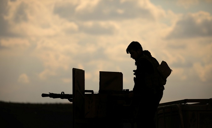A member of Syrian Democratic Forces (SDF) stands on a pick up truck mounted with a weapon near Baghouz, Deir Al Zor province, Syria February 11, 2019.