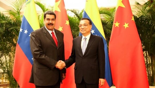 Venezuela's President Nicolas Maduro and Chinese Premier Li Keqiang shake hands during their meeting in Beijing, China Sep. 14, 2018. Miraflores Palace/