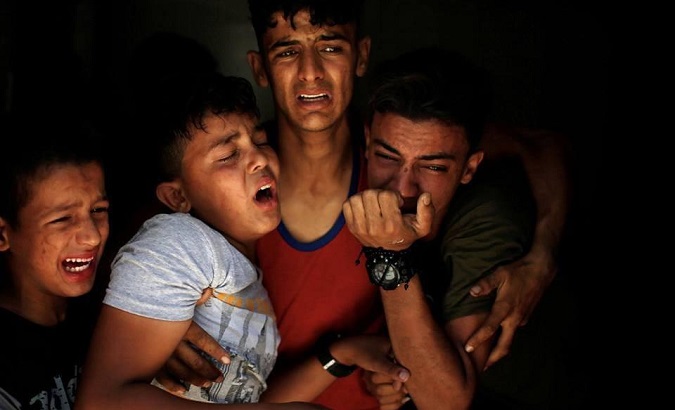 Palestinian photographer Mohammed Salem won an Excellence Award for this photograph of four Palestinian children crying while saying goodbye to their brother, who was killed May 15, during protests in Gaza.