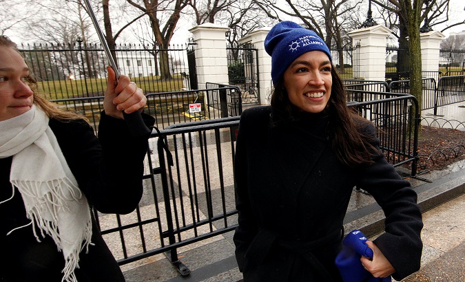 Rep. Alexandria Ocasio-Cortez leaves after addressing immigration rights activists during a rally in front of the White House in Washington.