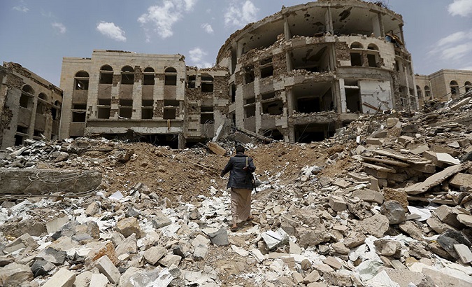 A Houthi militant walks through a government compound following Saudi-led air strikes, in the northwestern city of Amran in July 2015.