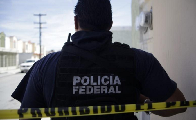 A federal police officer near a crime scene in Apodaca on the outskirts of Monterrey Feb. 26, 2012