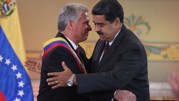 President Nicolas Maduro shakes hands with his Cuban counterpart Miguel Díaz-Canel during a state visit to Venezuela, May 30, 2018