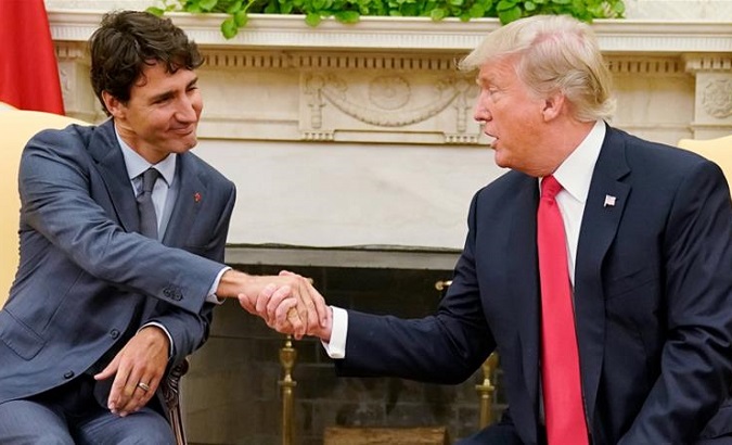 Canada's Prime Minister Justin Trudeau shakes hands with US President Donald Trump as they meet about the NAFTA trade agreement at the White House Oct. 2017.