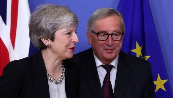 European Commission President Jean-Claude Juncket (R) and British PM Theresa May at the EC headquarters in Brussels.