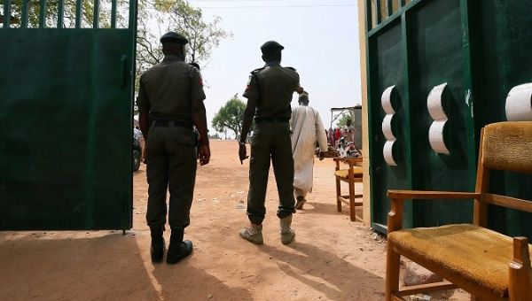 Police officers stand at the gate of the Independent National Electoral Commission (INEC) office in Daura, Katsina State, Nigeria February 22, 2019.