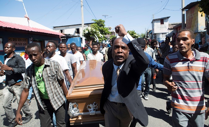 People carry the coffin of a victim of the Police crackdown in Port-au-Prince, Haiti, Feb. 22, 2019.