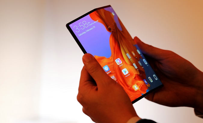 A Huawei staff member shows the new Huawei Mate X at the Mobile World Congress in Barcelona, Spain, Feb. 23, 2019.
