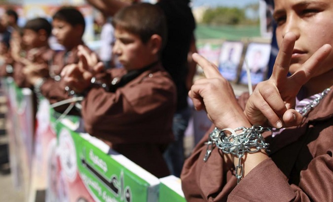 Palestinian children take part in a rally in front of the Red Cross headquarters.