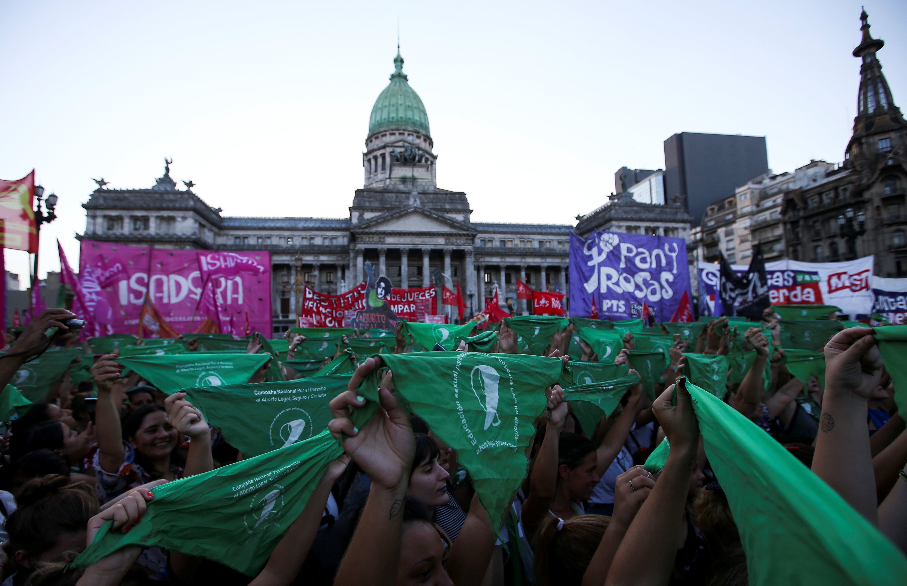 Abortion rights activists hold up green handkerchiefs, symbolize the abortion rights movement, outside the National Congress in Buenos Aires, Argentina, February 19, 2019