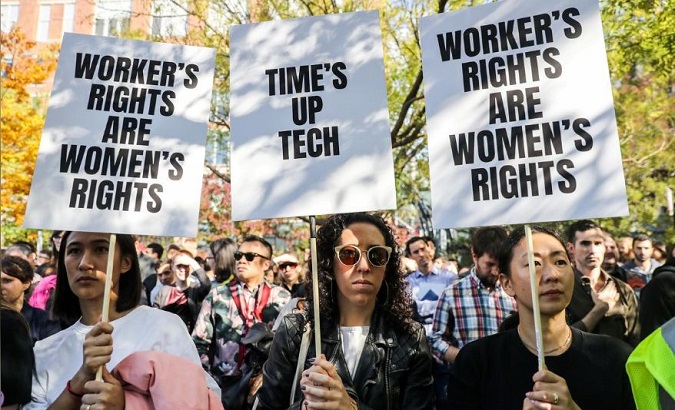 Workers hold signs outside 14th Street Park across the Google offices after walking out as part of a global protest over workplace issues in New York, U.S., Nov. 1, 2018.