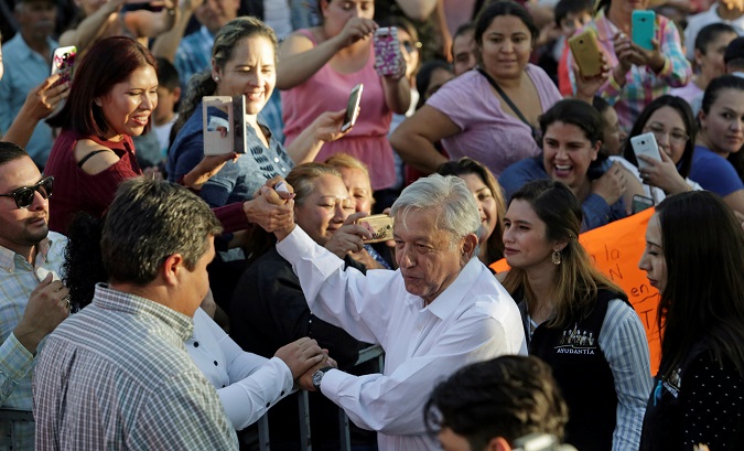 Mexico's President Andres Manuel Lopez Obrador greets people during his arrival to an event in Badiraguato.