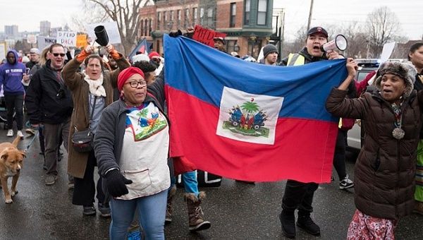 Haitian immigrants protest Trump immigration policies against TPS and DACA recipients.