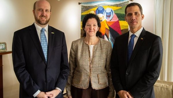 Juan Guaido and Kimberly Breier pose for a photo with Brazilian officials during his visit to Brazil earlier this week. 