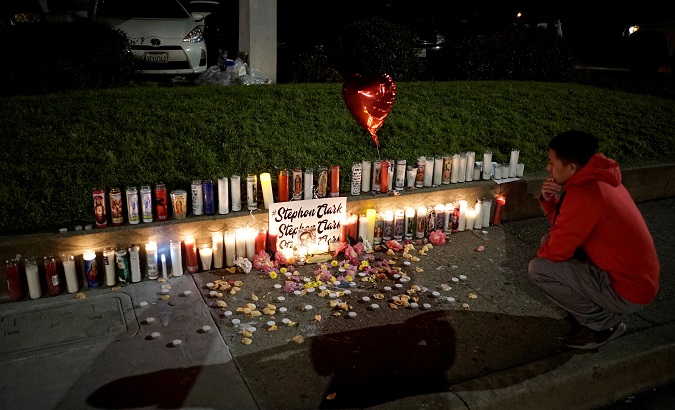 A man pauses at a sidewalk memorial to Stephon Clark, in Sacramento, California, U.S. March 23, 2018.