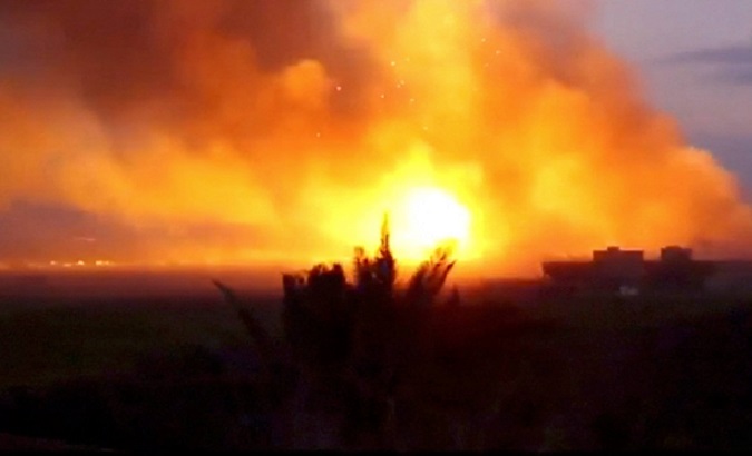A large explosion is seen as Kurdish fighters fire weapons at Islamic State held territory in Baghouz, eastern Syria in this still image taken from a video published March 4, 2019.