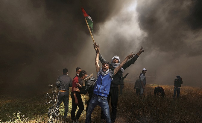 Palestinian demonstrators shout during clashes with Israeli troops at a protest at the Israel-Gaza border east of Gaza City.