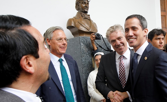 German envoy to Venezuela Daniel Martin Kriener and Juan Guaido shake hands during a news conference in Caracas.