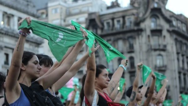 Women participate in a rally on the first anniversary of the 