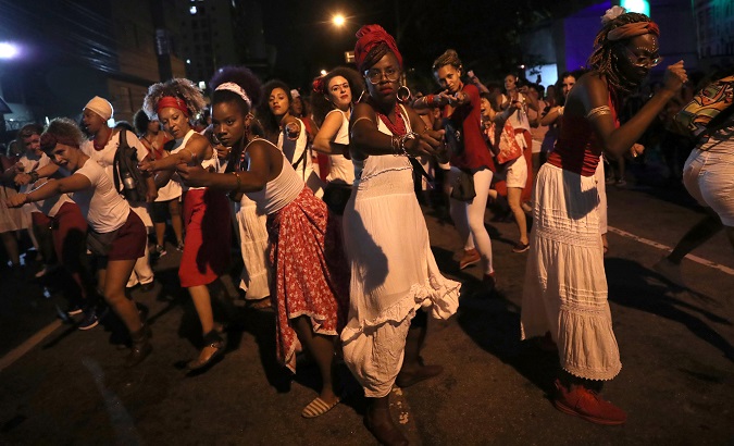 Women dance during a protest against Brazil President Jair Bolsonaro in Sao Paulo, Brazil March 8, 2019.