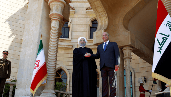 Iraq's President Barham Salih shakes hands with Iranian President Hassan Rouhani during a welcome ceremony at Salam Palace in Baghdad, Iraq March 11, 2019