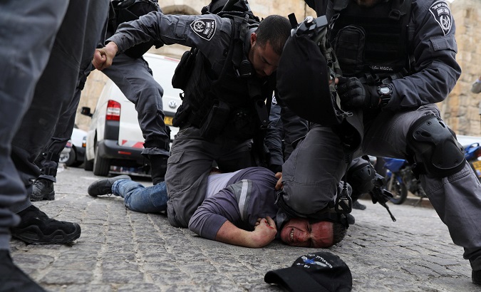 Israeli police officers detain a Palestinian protestor during scuffles outside the compound housing al-Aqsa Mosque in Jerusalem's Old City March 12, 2019.