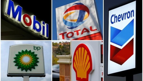 A combination of file photos shows the logos of five of the largest publicly traded oil companies; BP, Chevron, Exxon Mobil, Royal Dutch Shell, and Total.