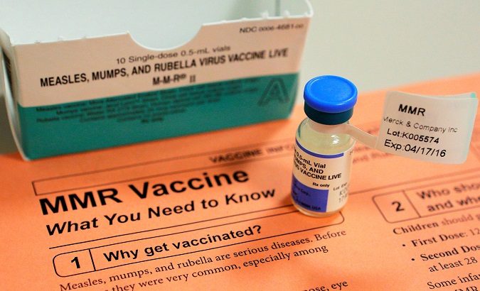 A vial of measles, mumps and rubella vaccine and an information sheet.