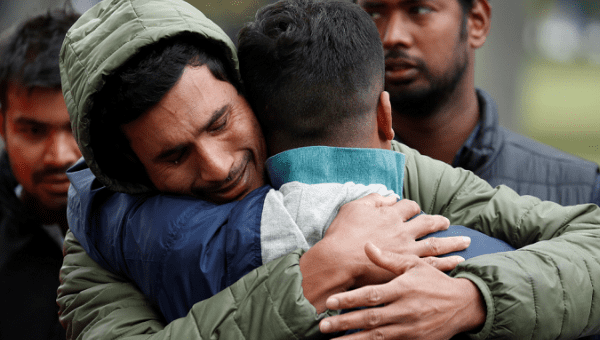 Mourners of the New Zealand mass murder hug outside the mosques where the killings took place. March 17, 2019