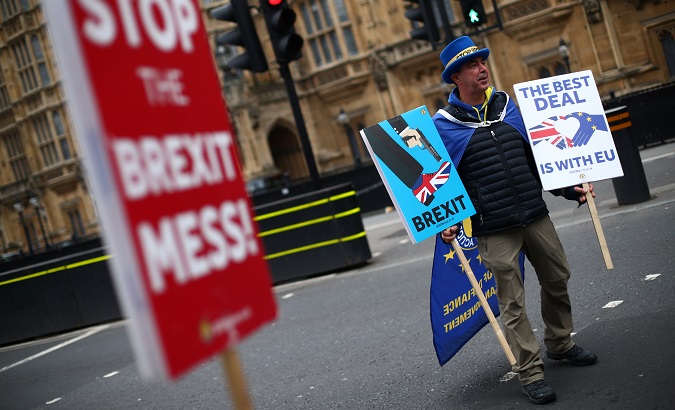 Anti-Brexit protester Steve Bray holds up signs outside the Houses of Parliament in London.