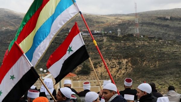 People holding Syrian and Druze flags in the Israeli-occupied Golan Heights, Feb. 14, 2019.