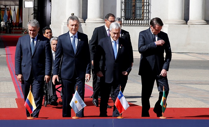 Presidents and delegates arrive to pose for a family photo during the Prosur summit, at the presidential palace La Moneda, in Santiago.