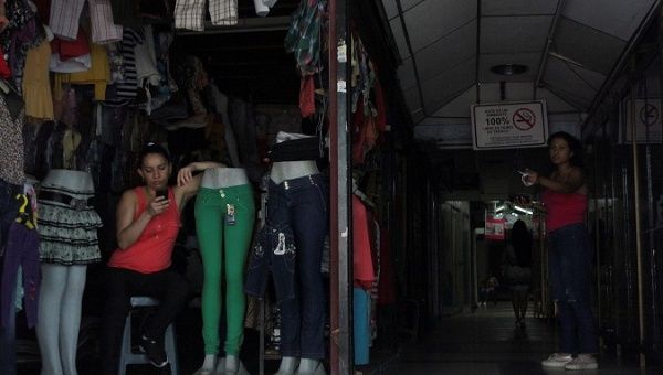 A woman keeps her business running despite the blackout in San Cristobal, Venezuela, March 26, 2019.