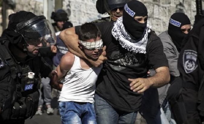 Israeli police detain a Palestinian child in Jerusalem following clashes Oct. 2014.