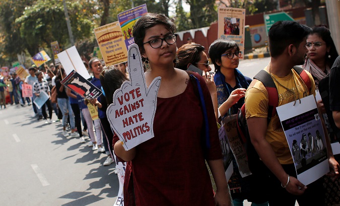 Women hold placards as they take part in a protest march demanding to vote and reject the current environment of hate and violence in the country, in New Delhi, India, April 4, 2019.