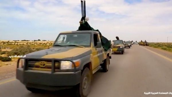 Military vehicles drive on a road in Libya, April 4, 2019, in this still image taken from video.