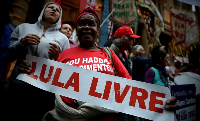 A woman holds a sign reading 'Free Lula' in Sao Paulo, Brazil, Oct. 5, 2019.