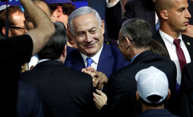 Israeli Prime Minister Benjamin Netanyahu is greeted by supporters of his Likud party.