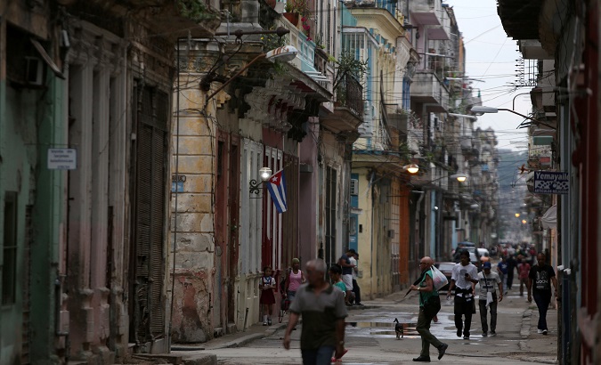 People walk on a street in Havana.