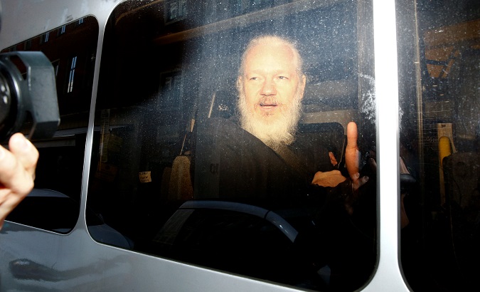 WikiLeaks founder Julian Assange is seen in a police van, after he was arrested by British police, in London.